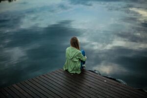 woman sitting on wooden planks