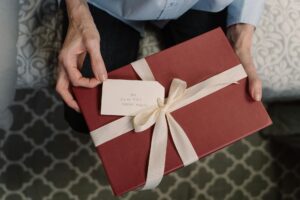 a person holding a box of gift