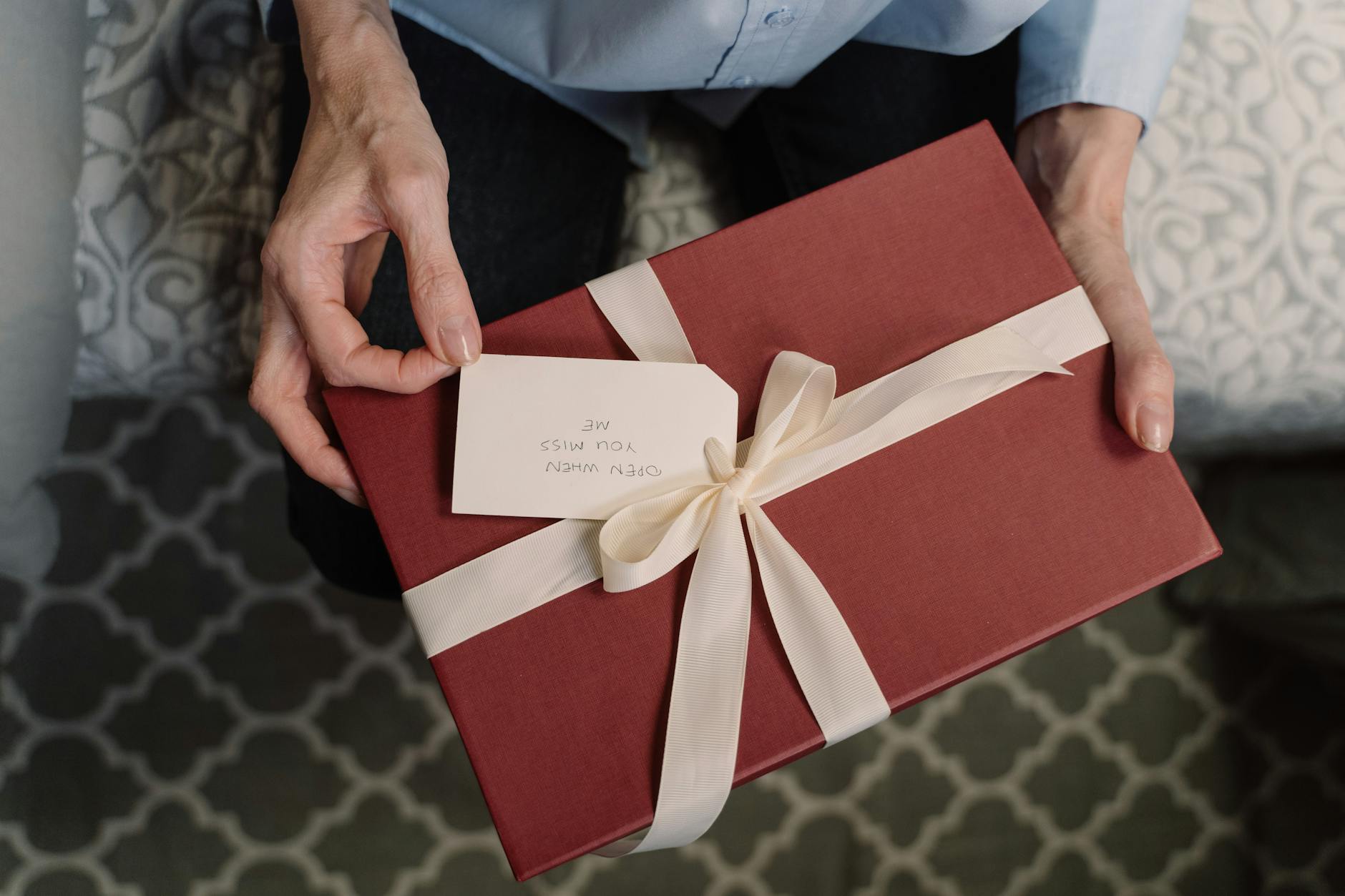 a person holding a box of gift