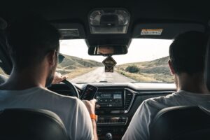 men driving car
