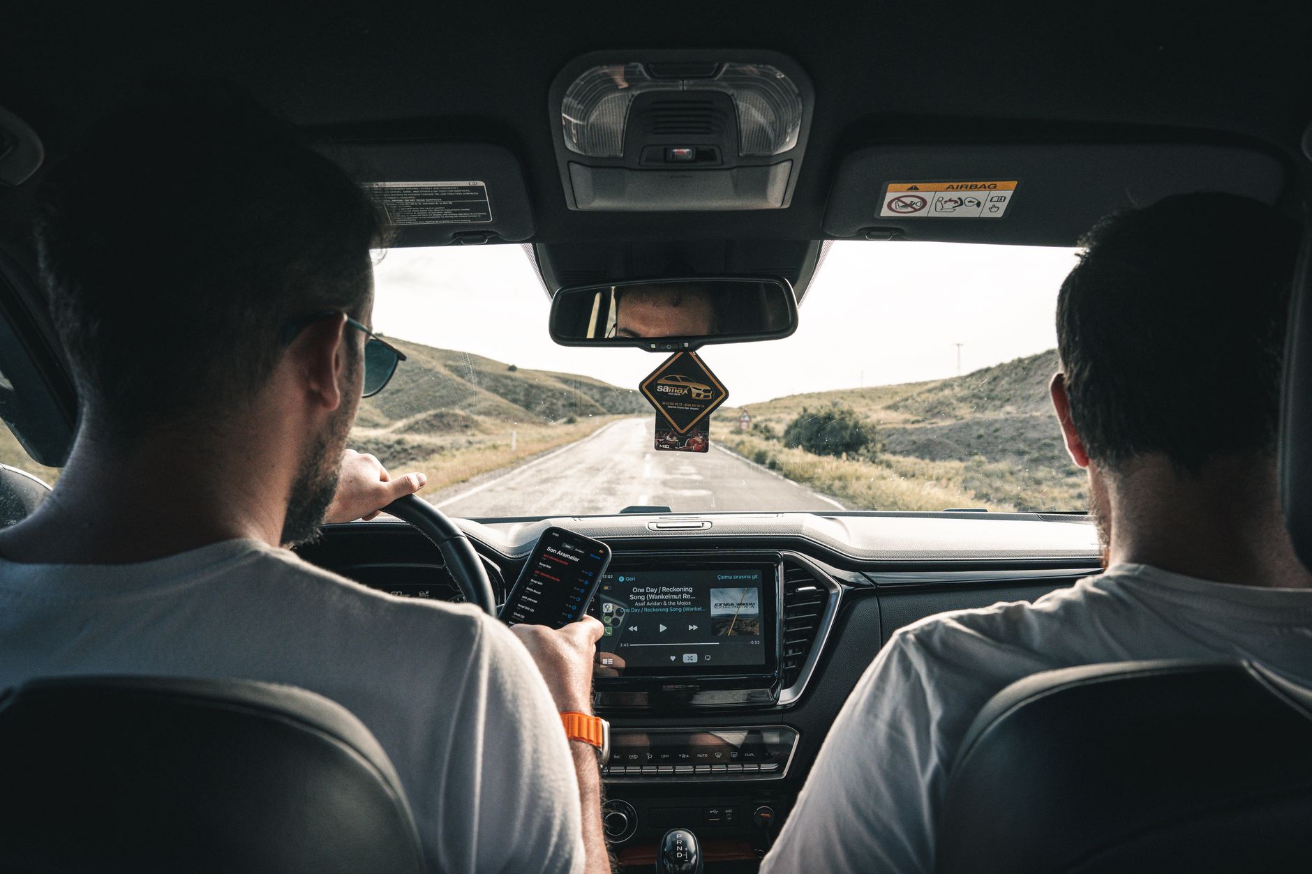 men driving car