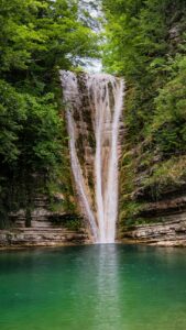 beautiful waterfall surrounded by lush greenery